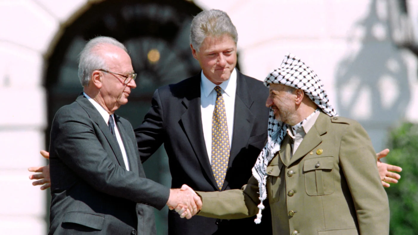 From left: Israeli Prime Minister Yitzahk Rabin, US President Bill Clinton and PLO leader Yasser Arafat after signing the Oslo Accords at the White House on 13 September 1993 (AFP) 